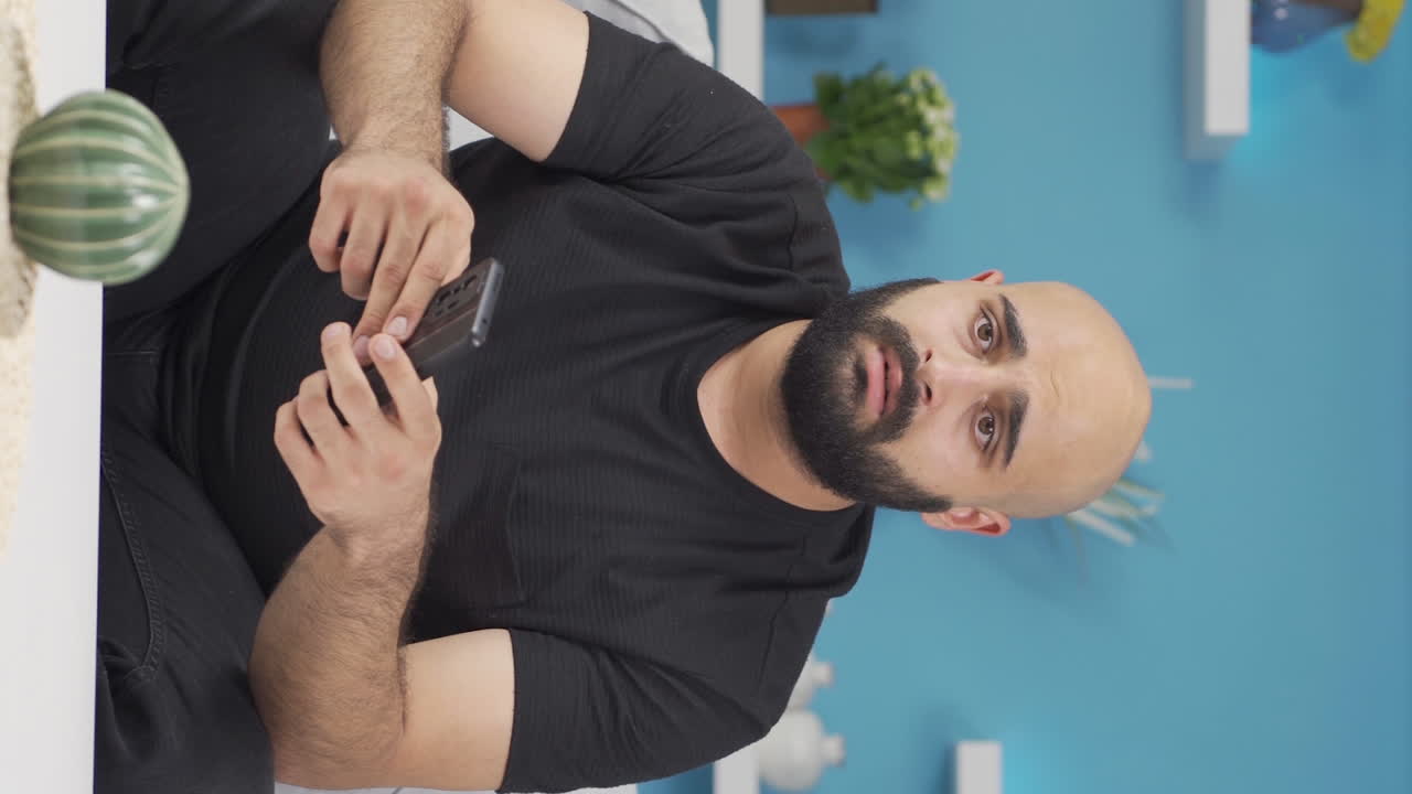 Vertical video of Disappointed man in messaging.