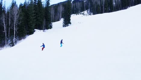 People-snowboarding-on-snowy-mountain