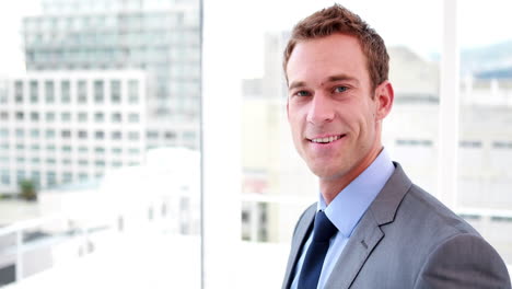 handsome businessman smiling at camera