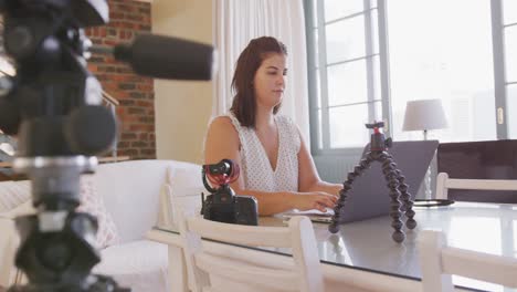 caucasian blogger woman doing  video montage at home