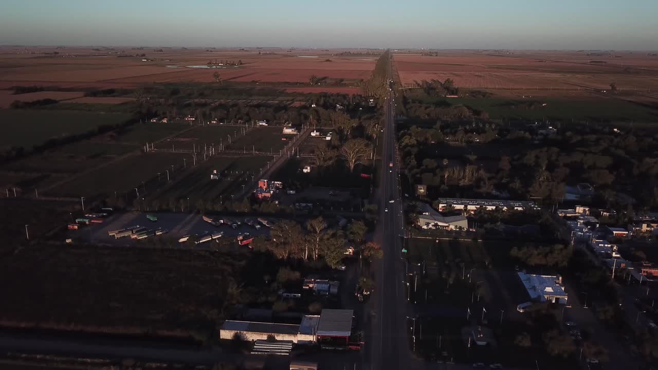 Aerial drone shot from Ruta 9 Cordoba Argentina with a truck parking down in the leftside in the sunset rural area