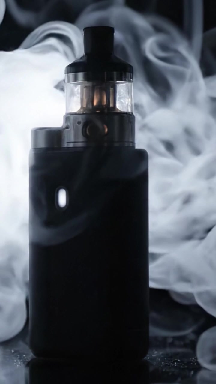A striking visual examination of a sleek vaping device, highlighted against a mysterious dark backdrop, exuding an atmosphere of intrigue and modernity.