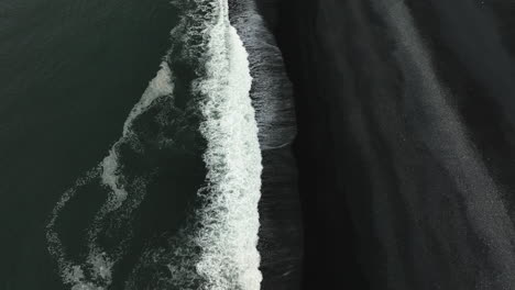 aerial view tilting over the stokksnes black sand beach, gloomy evening in iceland