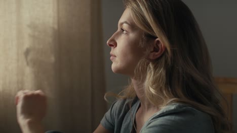 Caucasian-woman-sitting-at-the-bed-and-looking-away-with-contemplation