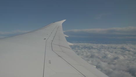 view form the window of a plane flying over the clouds