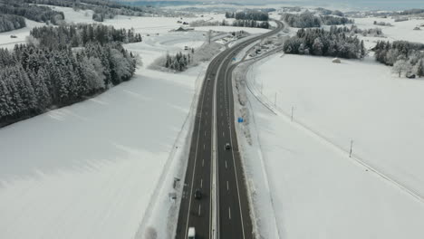 flying over highway running through beautiful snow covered landscape