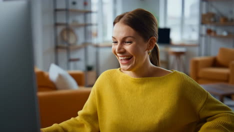 happy woman working on computer at home