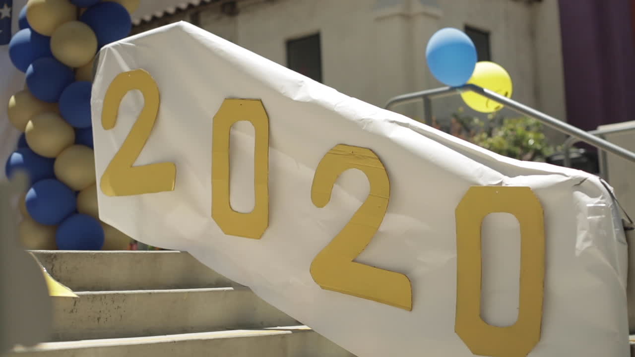2020 Celebration Sign with Balloons on School Front Steps, Slow Motion