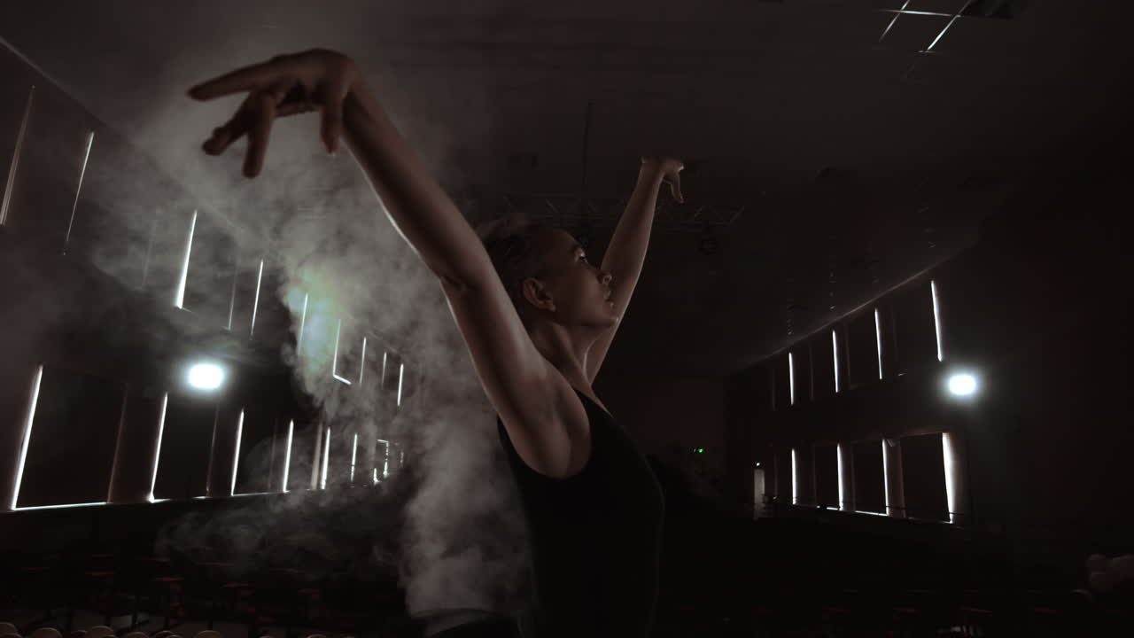 Graceful Ballerina In White Dress Dancing Elements Of Classical Or Modern Ballet In The Dark With