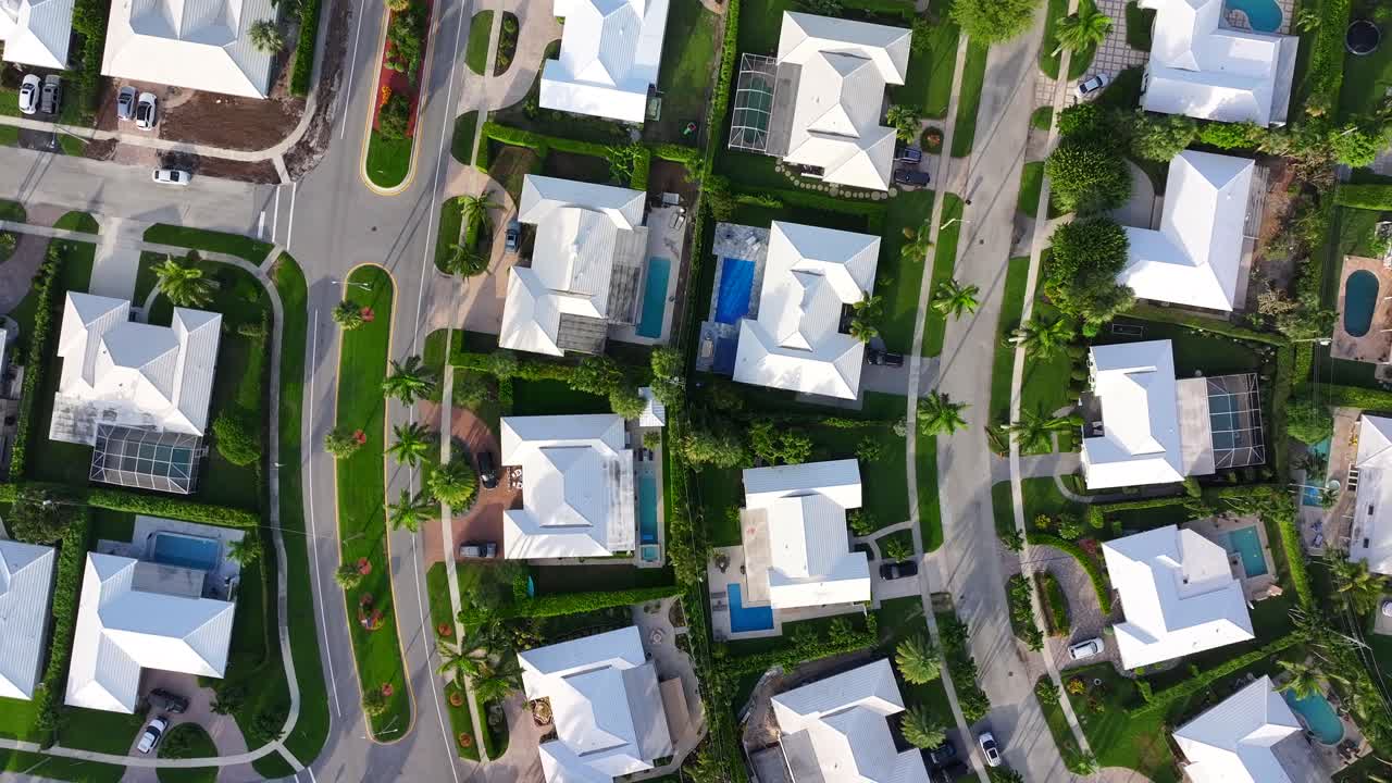Overhead view of suburban homes with swimming pools and well-maintained yards in Boca Raton, Florida