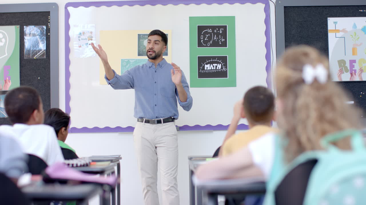 Young Asian man teaches in a vibrant school classroom