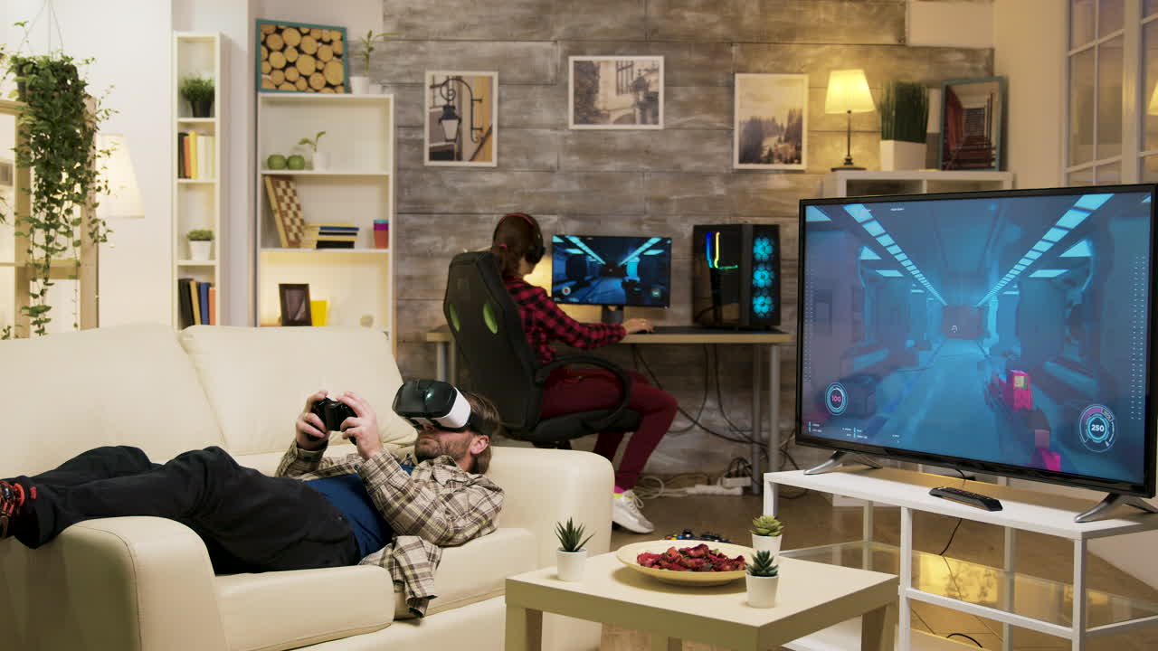 Man Using VR Headset While Another Plays PC Games