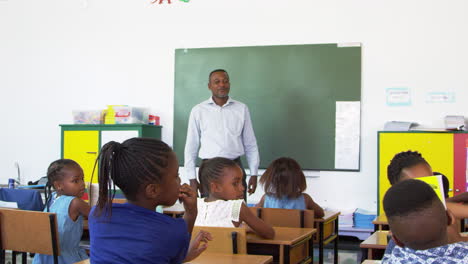 teacher and kids talking in an elementary school lesson