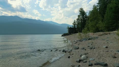 beach on kootenay lake british columbia with forest fire smoke in the air