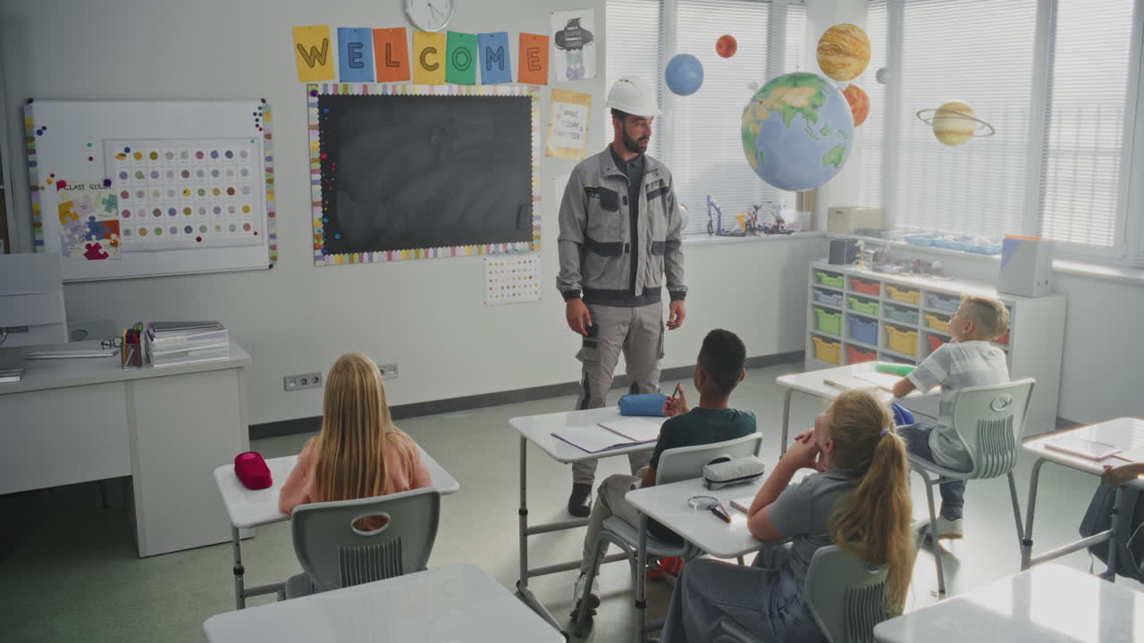 Engineer in Uniform Speaking and Giving Lecture to Curious Primary School Students About Engineering