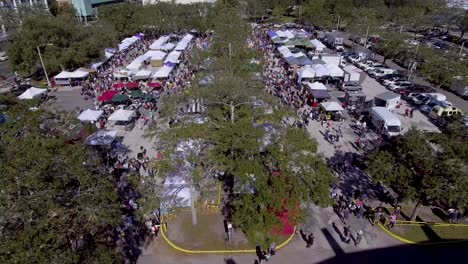 4k aerial drone video of shoppers at farmers market in downotwn st