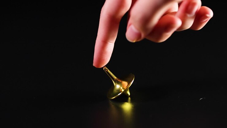 Hand interacting with a spinning top