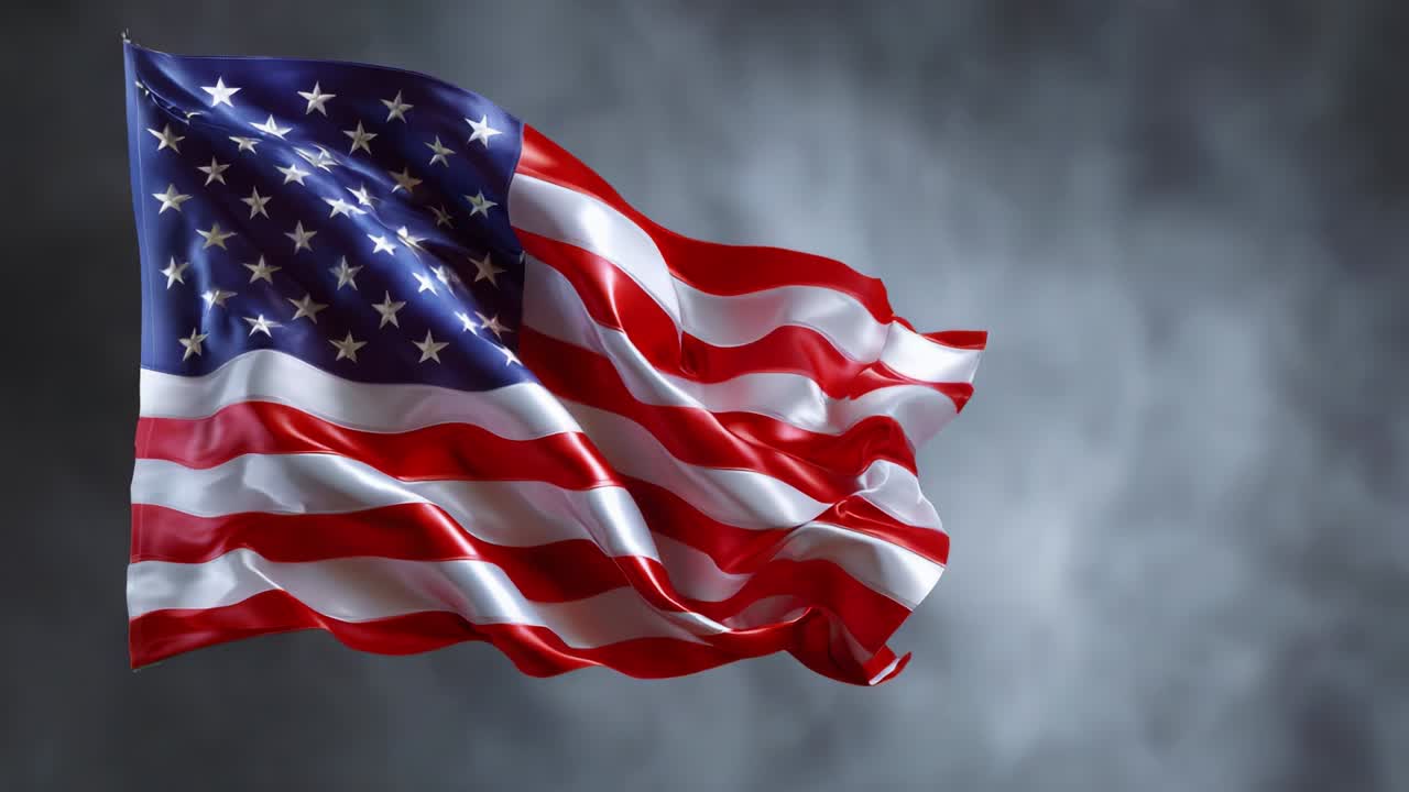A beautiful and dynamic representation of a waving flag, showcasing the vibrant colors and iconic stars and stripes that symbolize freedom and unity, set against a dramatic gray backdrop, celebrating patriotism