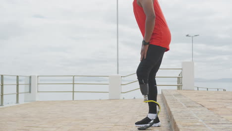 side view man with prosthetic leg walking and sitting