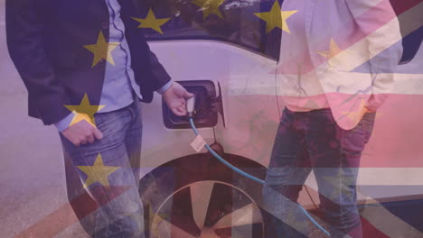 flag of great britain and european union over man charging electric car