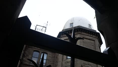 Bidston-hill-historic-astronomy-observatory-tower-though-ornate-iron-entrance-gates-right-dolly