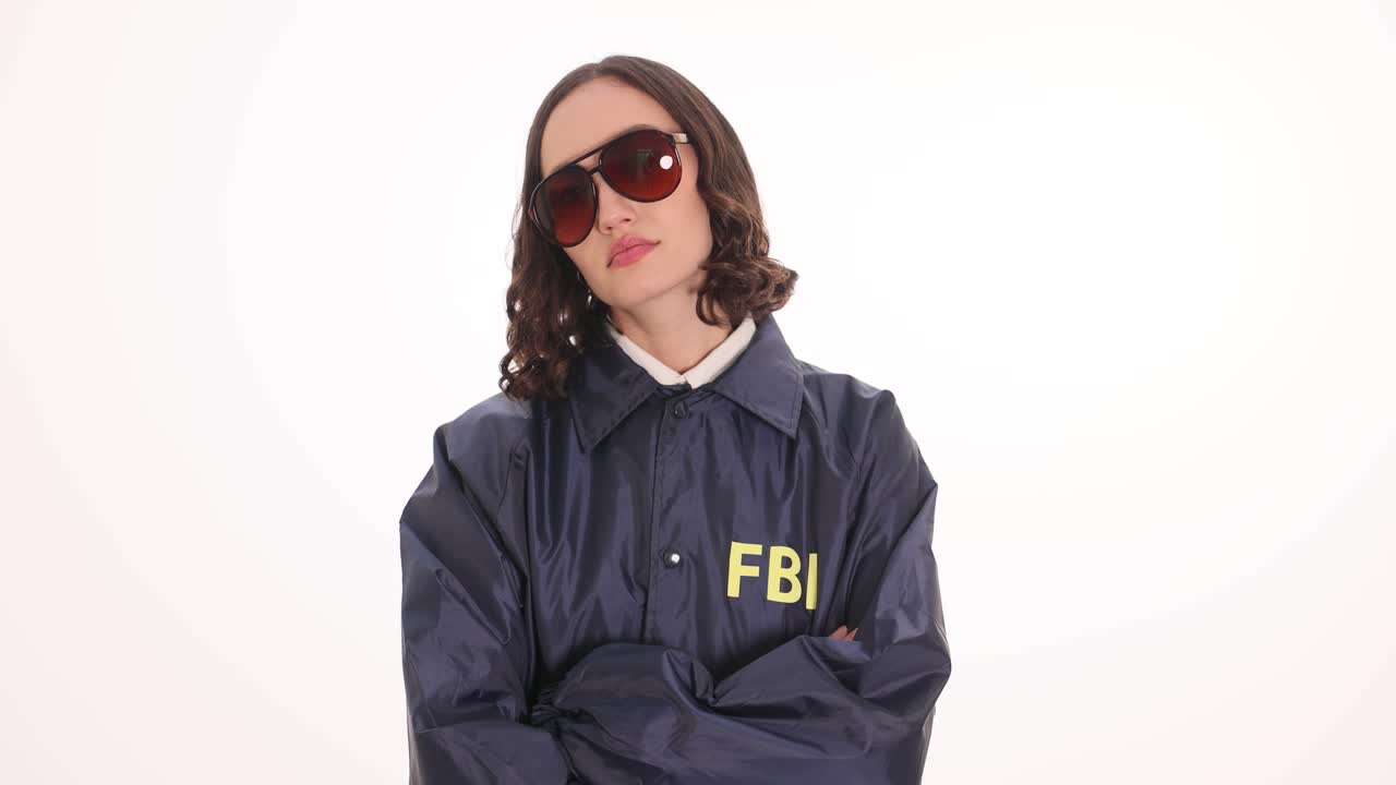 A woman with sunglasses and an FBI jacket