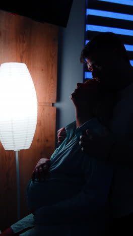 pregnant woman with her partner in the night