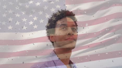 Animation-of-flag-of-america-and-confetti-falling-over-portrait-of-african-american-happy-young-man