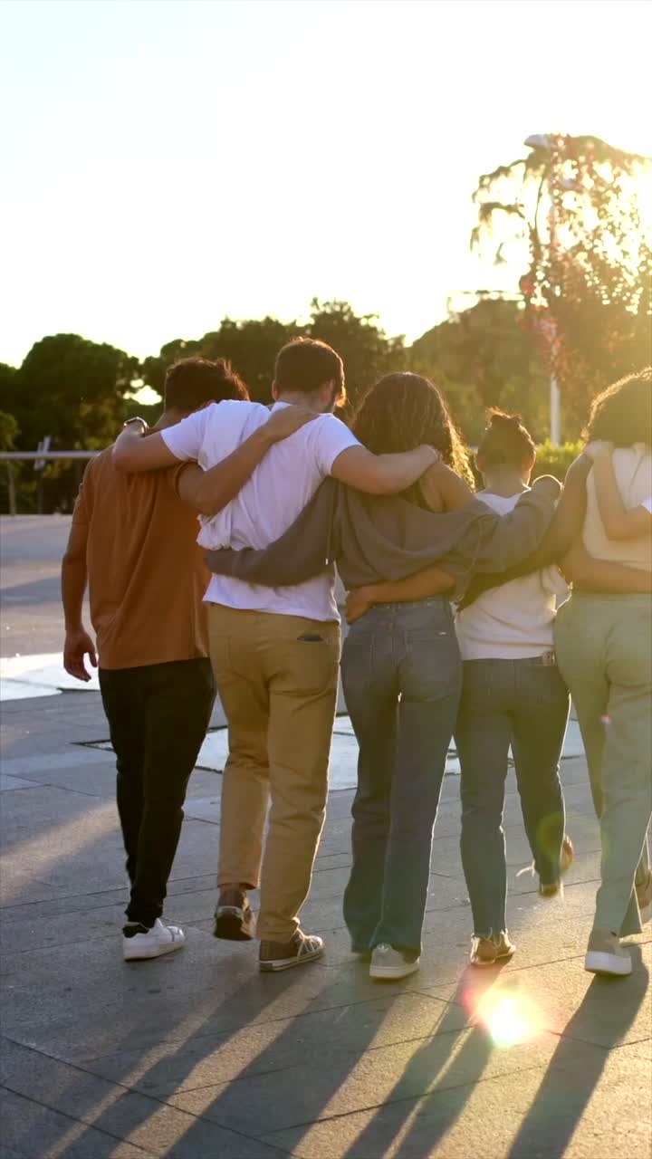 Group of friends walking at sunset