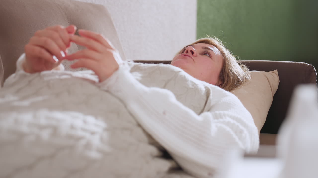 Emotional traveler lying on comfortable couch discussing feelings with hands clasped conveying introspection and healing in soft lit therapy space conveying vulnerability and calm reflective mood