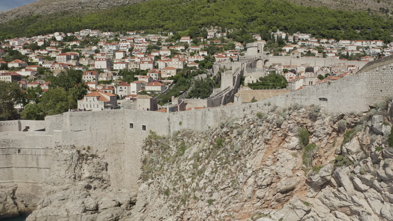Walled Old Town of Dubrovnik Croatia with village in the background.