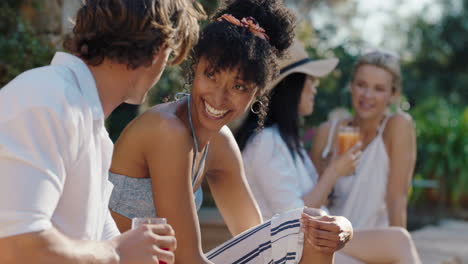 beautiful woman chatting to man young couple sitting by swimming pool enjoying relaxing summer day 4k