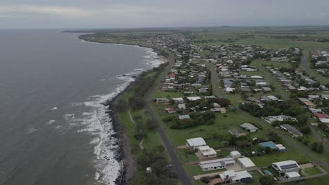 waves crashes on rocky shore of bundaberg coastal town in queensland, australia