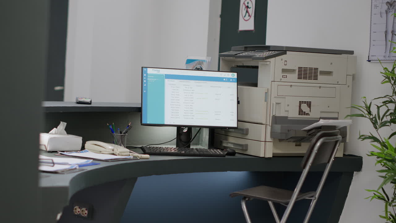 Office reception area with computer and printer