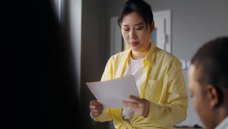 woman reading document in meeting