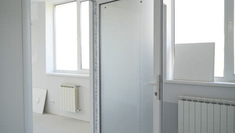 red locker box with firefighting equipment inside. white interior of newly-constructed office premises.