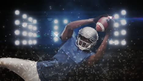 digital composite video of silver sparkles moving against male rugby player catching a rugby ball