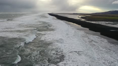 Aerial-of-waves-lapping-the-shoreline-of-Reynisfjara-Black-Sand-Beach-on-the-south-coast-of-Iceland