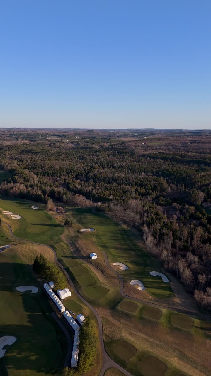 Vertical, push in drone shot of TPC Toronto at Osprey Valley Golf Course during the day in Alton, Caledon, Ontario, Canada