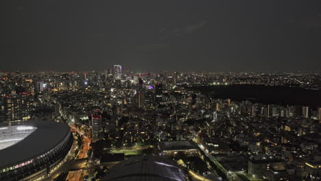 tokyo japan aerial v181 drone flyover sendagaya capturing sports stadium and arena, yoyogi park and shibuya downtown cityscape at night - shot with mavic 3 pro cine - october 2023