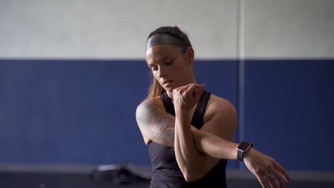 exhausted female athlete stretching after workout