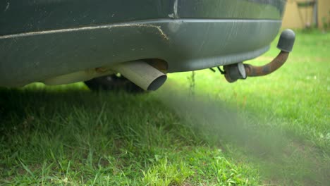 slow motion: smoke billows from tail pipe, pollution concept