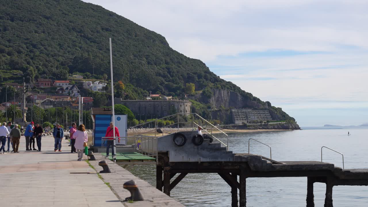 Coastal Town with Jetty and Mountain View
