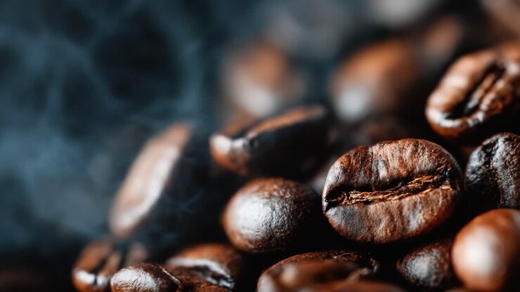 Aromatic Espresso Coffee Beans Releasing Fragrant Steam, Capturing the Essence of Freshly Roasted Rich Flavors and Inviting Warmth in a Close-up View