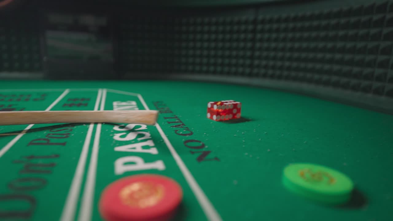 A close-up shot of Santa Claus reaching for red craps dice rolling across a green casino table