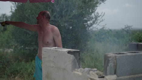 shirtless man working outdoors at a construction site