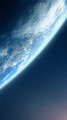 vertical format : a cinematic rendering of planet earth during sunrise as view from space with vibrant blue sky atmosphere