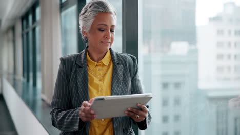 mature businesswoman using tablet in office