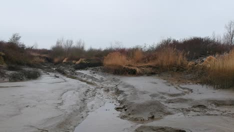 dried river bed in aerial low altitude drone truck shot