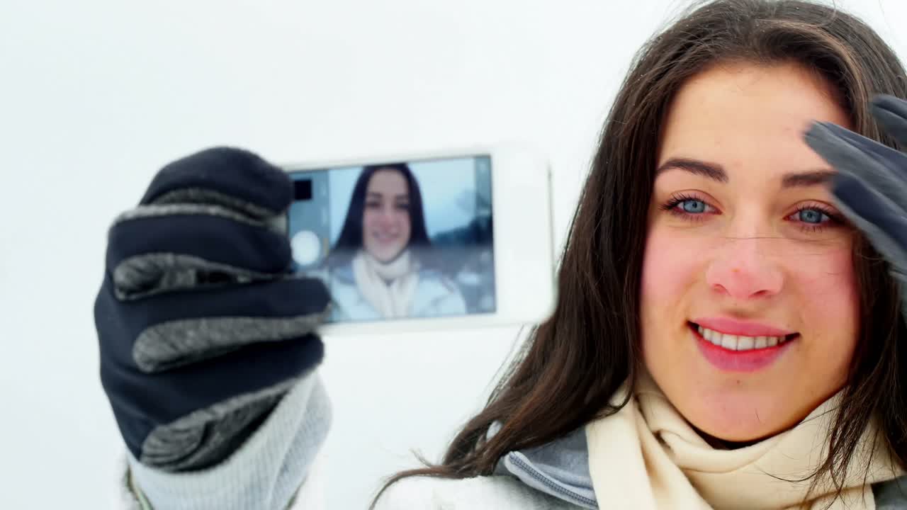 mujer sonriente tomando una selfie en el teléfono móvil